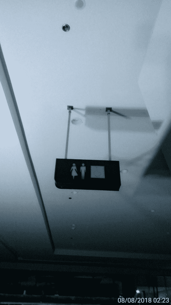 Acrylic ceiling-mounted restroom signage with male and female icons in Makati, timestamped, by M&G Global Ads.